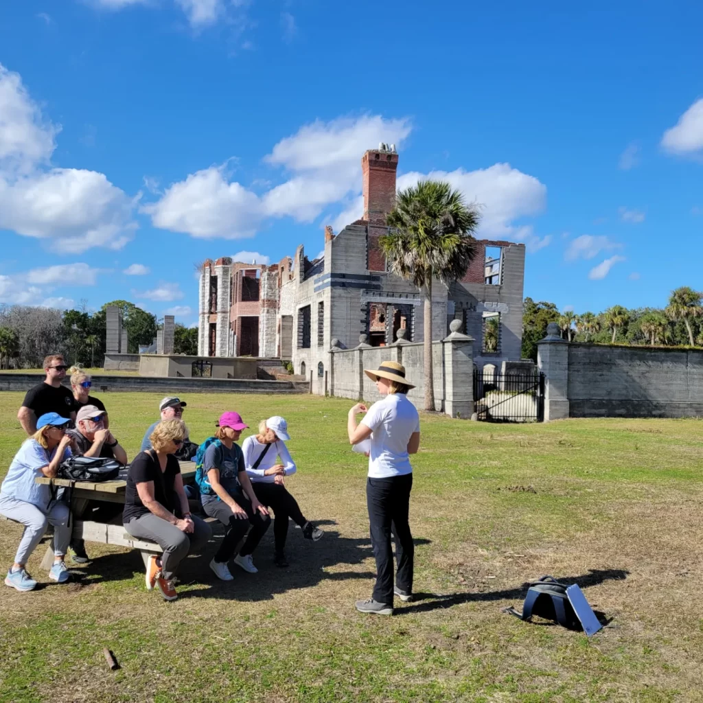Molly's Old South Tours group learning about he Carnegies in front of their Dungeness Mansion