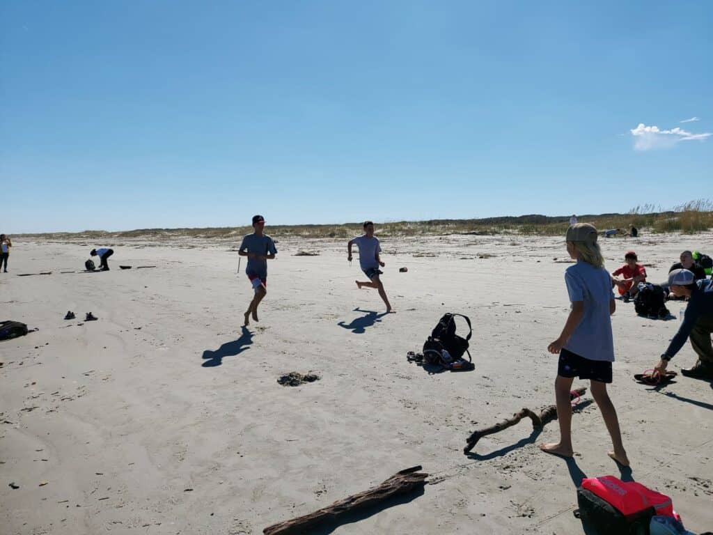 Molly's Old South Tours field trip group playing relay races the Carnegies would have played at Cumberland Island's beach