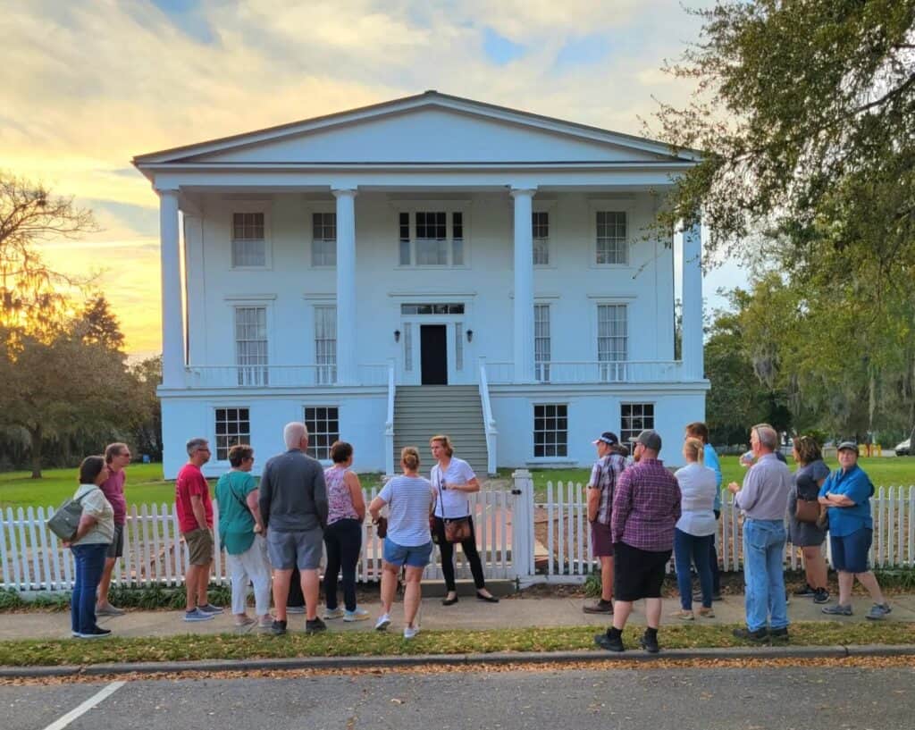 Molly's Old South Tours group enjoying a sunset tour in front of historic Orange Hall